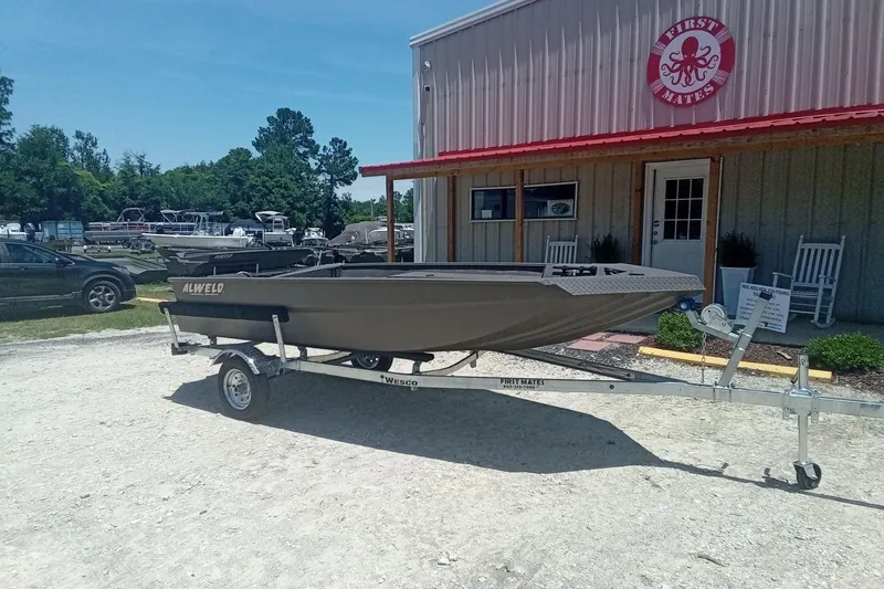 Slide: The Image of 2026 Alweld 1548 Invader boat on trailer outside First Mates building. - 3
