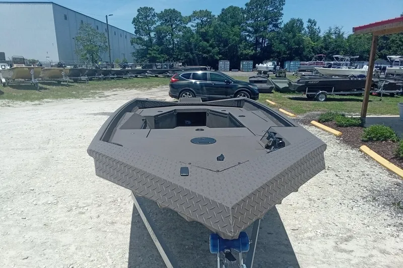 Slide: The Image of 2026 Alweld 1548 Invader boat displayed outdoors in a dealership lot. - 4