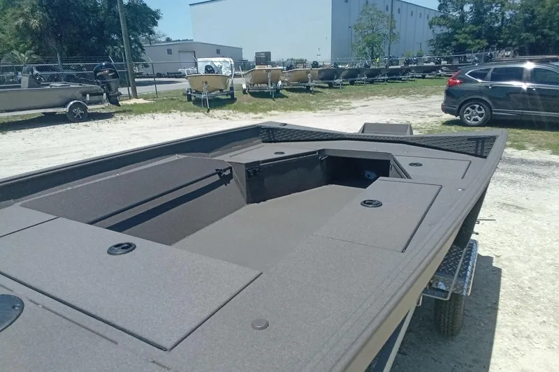 Slide: The Image of 2026 Alweld 1548 Invader boat on trailer, parked outdoors in a lot. - 6