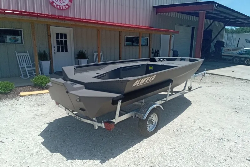 Slide: The Image of 2026 Alweld 1548 Invader boat on trailer, parked outside a building. - 9