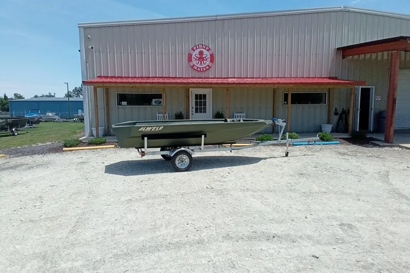 Slide: The Image of 2026 Alweld 1548 Invader boat on trailer outside a metal building. - 11