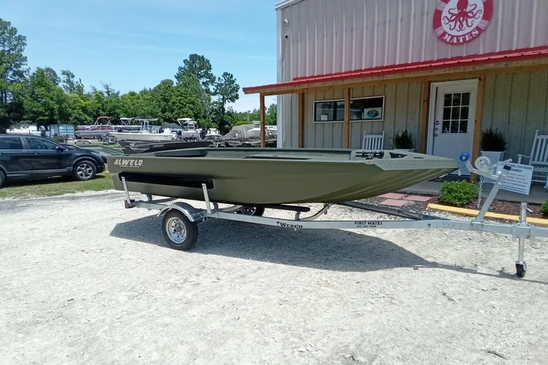 Slide: The Image of 2026 Alweld 1548 Invader boat on trailer outside a building. - 12