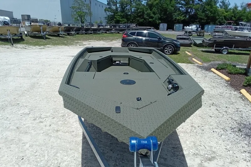 Slide: The Image of 2026 Alweld 1548 Invader boat in outdoor showroom, showcasing rugged design and durability. - 13