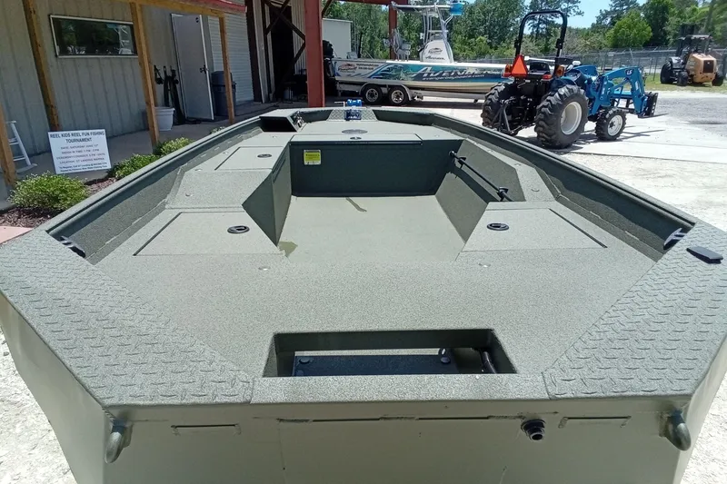 Slide: The Image of 2026 Alweld 1548 Invader boat with spacious deck, parked outdoors. - 17