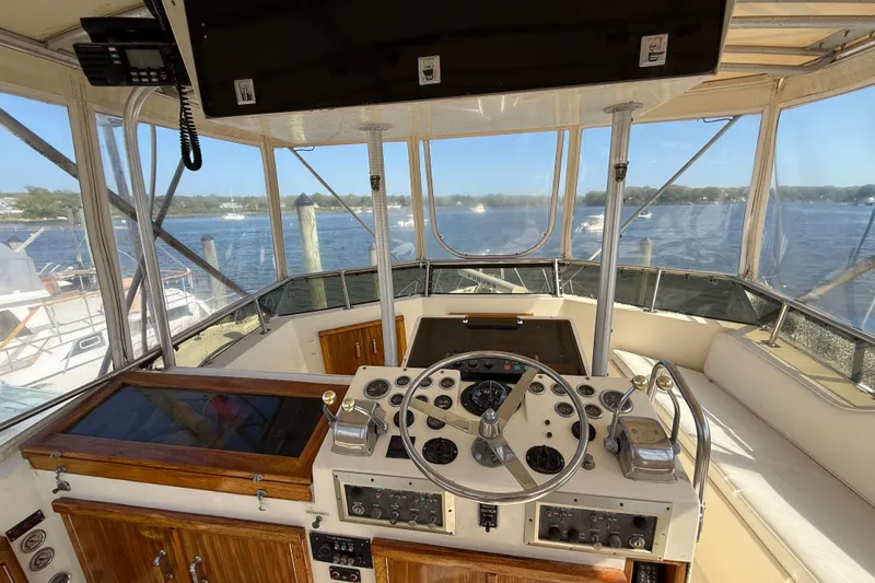 Slide: The Image of 1979 Hatteras 46 Convertible yacht helm with panoramic water views. - 15