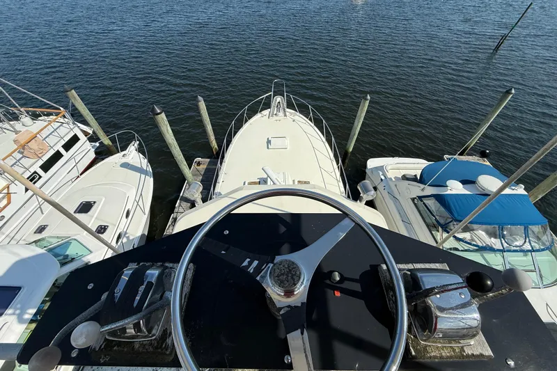 Slide: The Image of View from the helm of a 1979 Hatteras 46 Convertible yacht docked at a marina. - 18