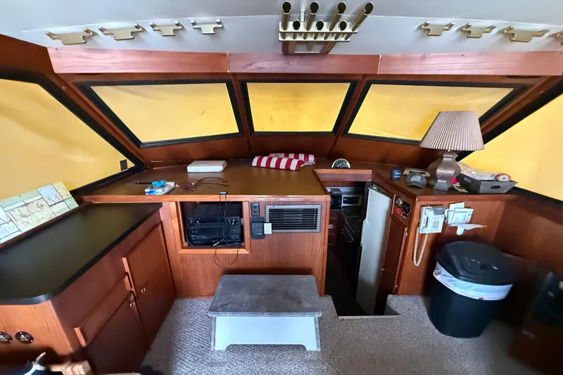 Slide: The Image of Interior of a 1979 Hatteras 46 Convertible yacht with wood paneling and nautical decor. - 23