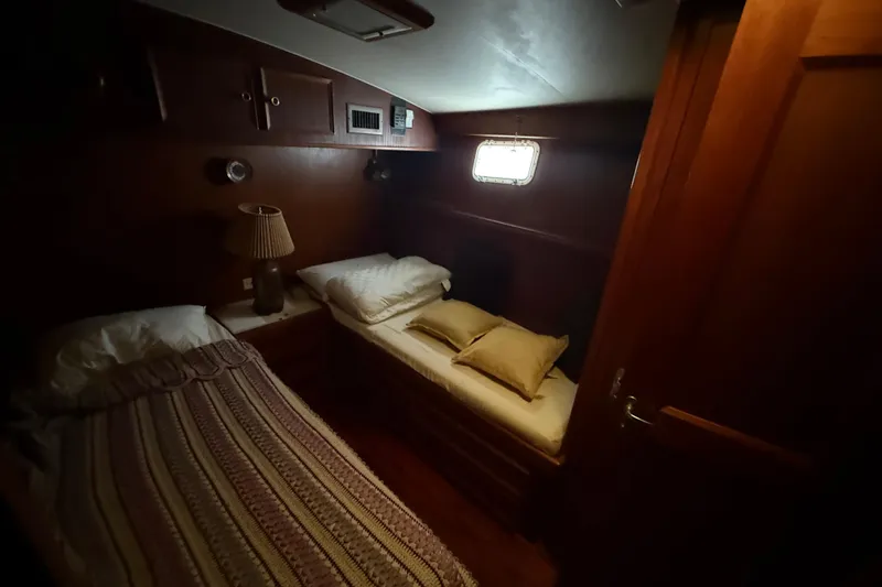 Slide: The Image of Cozy cabin interior of 1979 Hatteras 46 Convertible yacht with twin beds and warm lighting. - 27