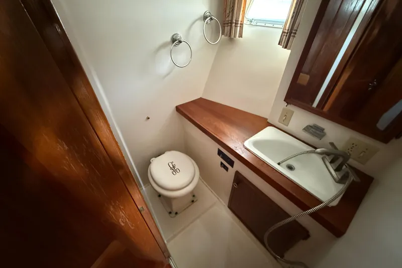 Slide: The Image of Bathroom interior of 1979 Hatteras 46 Convertible yacht with sink and toilet. - 29