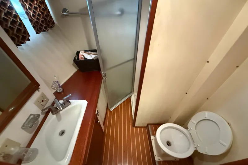 Slide: The Image of 1979 Hatteras 46 Convertible yacht bathroom with sink, toilet, and shower. - 30