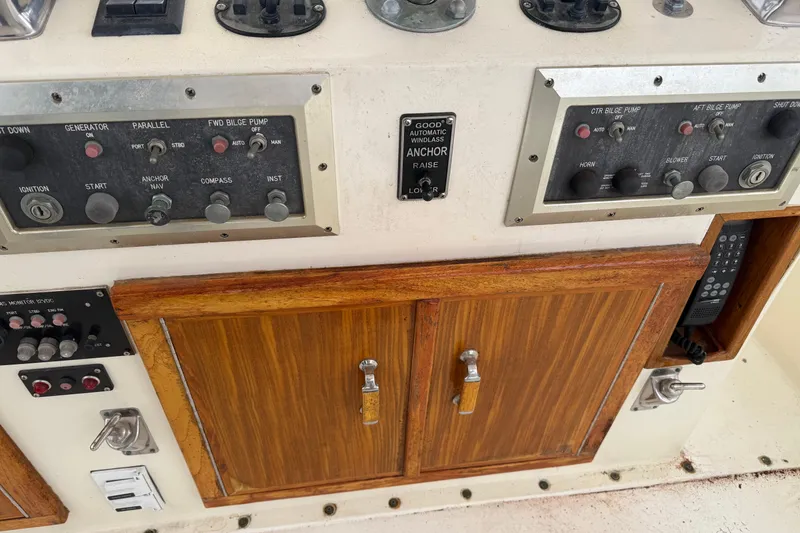 Slide: The Image of Control panel of a 1979 Hatteras 46 Convertible boat with wooden cabinet. - 32