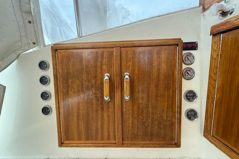 Slide: The Image of Wooden cabinet with gauges on a 1979 Hatteras 46 Convertible boat interior. - 33