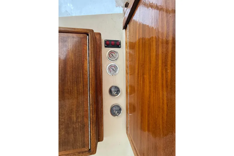 Slide: The Image of Wooden dashboard with gauges on a 1979 Hatteras 46 Convertible boat. - 35