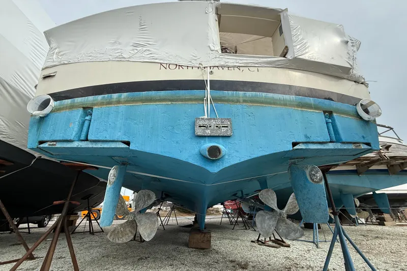 Slide: The Image of 1979 Hatteras 46 Convertible boat on stands, showing propellers and hull. - 41