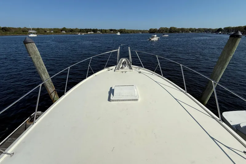 Slide: The Image of Bow view of 1979 Hatteras 46 Convertible yacht on calm water. - 9