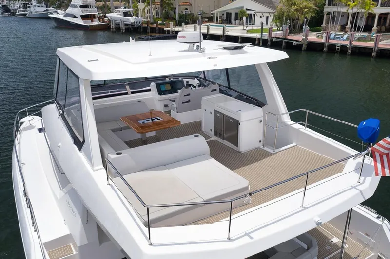 Slide: The Image of 2024 Leopard 46 Powercat yacht with spacious deck, modern seating, and waterfront view. - 11