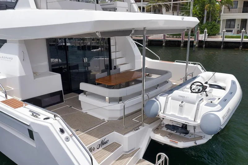 Slide: The Image of 2024 Leopard 46 Powercat yacht with a sleek deck and attached inflatable boat. - 14