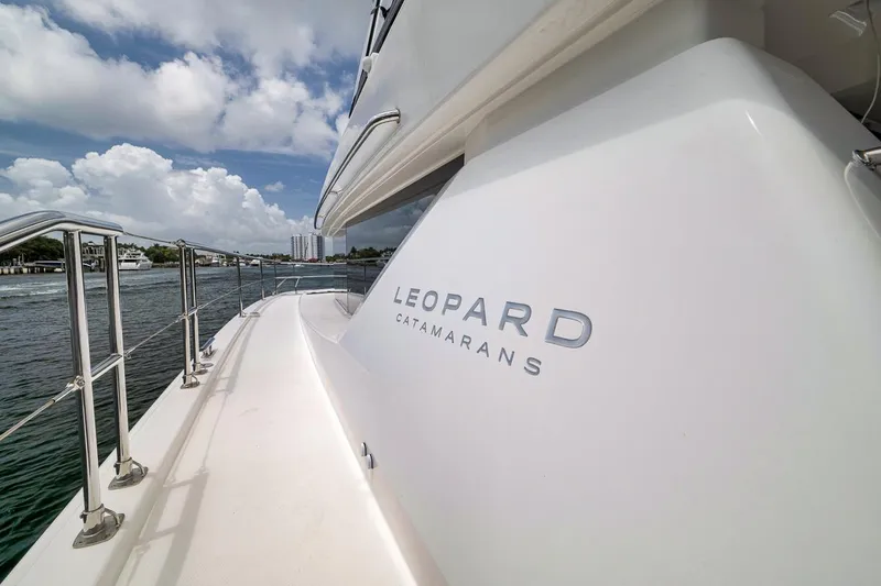 Slide: The Image of 2024 Leopard 46 Powercat catamaran on water, showcasing sleek design and branding. - 22
