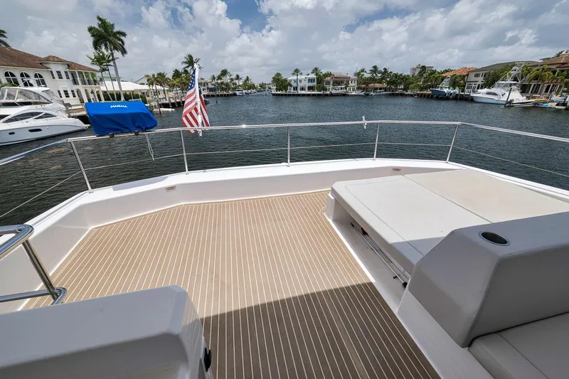 Slide: The Image of Deck view of 2024 Leopard 46 Powercat yacht, overlooking marina with American flag. - 35