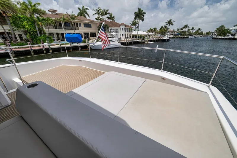 Slide: The Image of 2024 Leopard 46 Powercat deck with seating, overlooking waterfront homes and palm trees. - 36