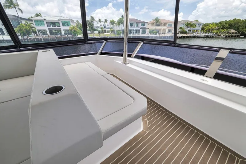 Slide: The Image of 2024 Leopard 46 Powercat interior with sleek seating and waterfront view. - 38