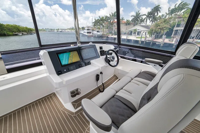 Slide: The Image of 2024 Leopard 46 Powercat helm with modern navigation screens and luxurious seating. - 39