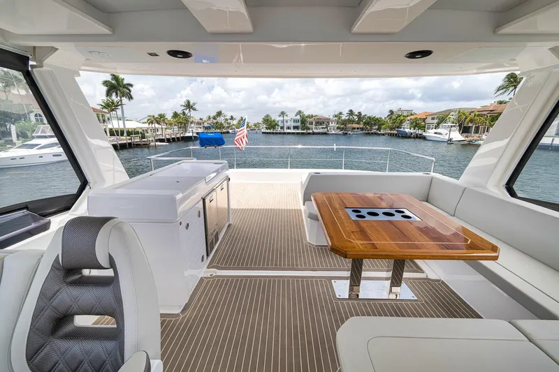 Slide: The Image of Luxurious 2024 Leopard 46 Powercat yacht interior with elegant seating and waterfront view. - 42