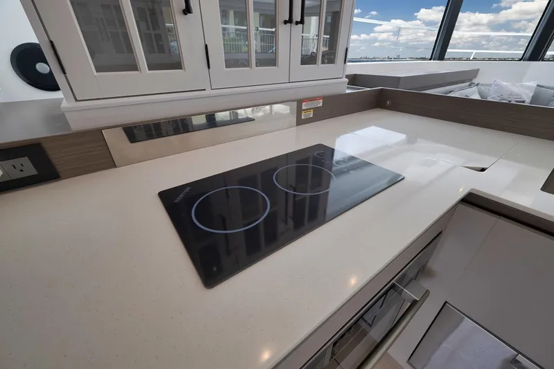 Slide: The Image of Modern kitchen in 2024 Leopard 46 Powercat with sleek induction cooktop and cabinetry. - 56