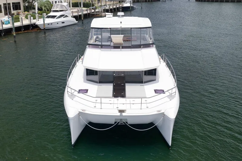 Slide: The Image of 2024 Leopard 46 Powercat yacht docked in marina, showcasing sleek design and spacious deck. - 6