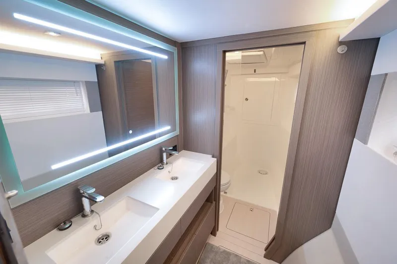 Slide: The Image of Modern bathroom interior of 2024 Leopard 46 Powercat with dual sinks and illuminated mirror. - 64