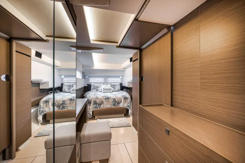 Slide: The Image of Luxurious bedroom interior of 2024 Leopard 46 Powercat with modern wood finishes and mirrored accents. - 67