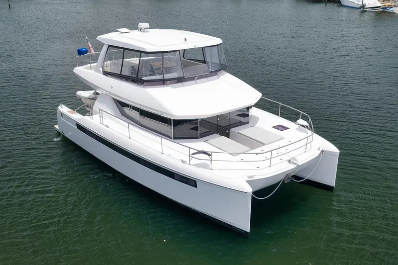 Slide: The Image of 2024 Leopard 46 Powercat yacht on calm water, showcasing sleek design and spacious deck. - 7