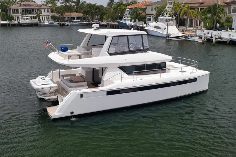 Slide: The Image of 2024 Leopard 46 Powercat yacht docked in a serene marina setting. - 9