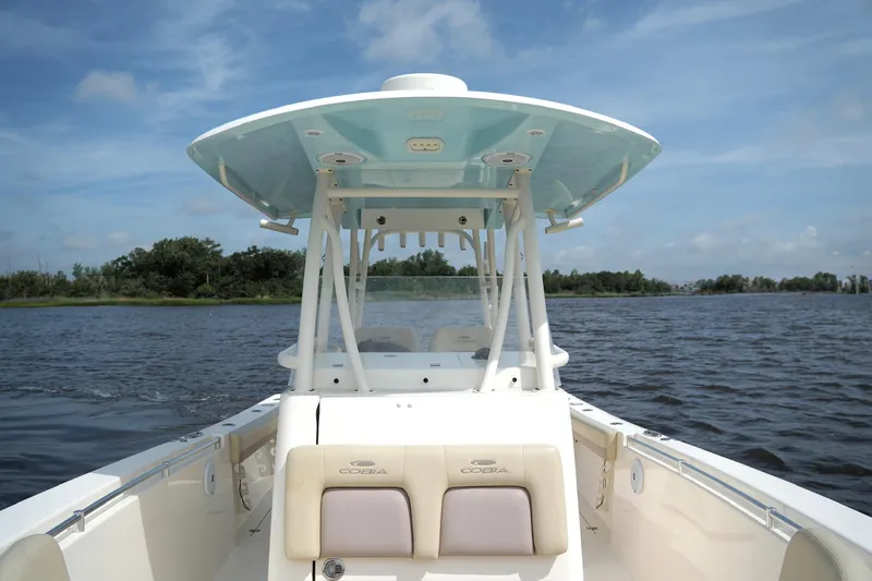Slide: The Image of 2016 Cobia 296 Center Console boat on calm water under blue sky. - 10