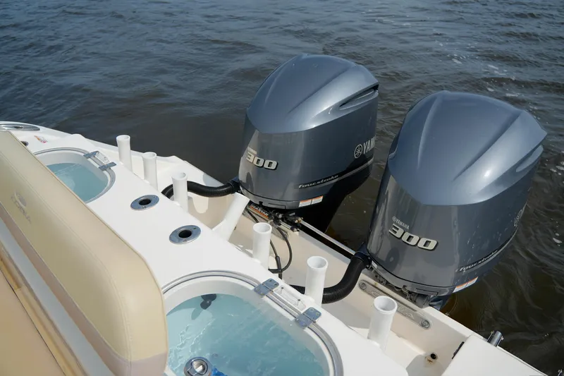 Slide: The Image of 2016 Cobia 296 Center Console with twin Yamaha 300 engines on water. - 11