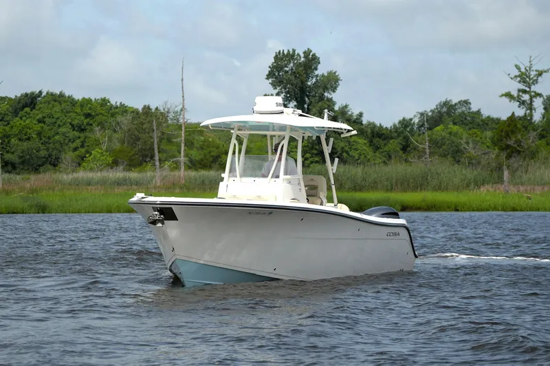 Slide: The Image of 2016 Cobia 296 Center Console boat cruising on a scenic river. - 12