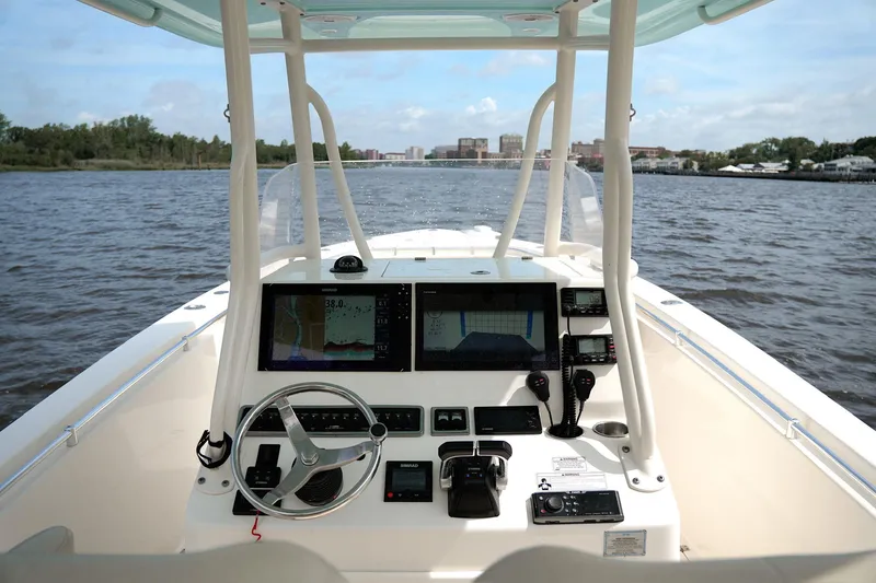 Slide: The Image of 2016 Cobia 296 Center Console boat dashboard with navigation equipment on open water. - 5