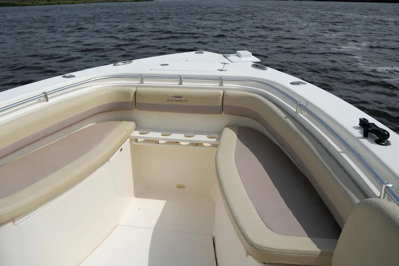 Slide: The Image of 2016 Cobia 296 Center Console boat interior with cushioned seating on open water. - 7