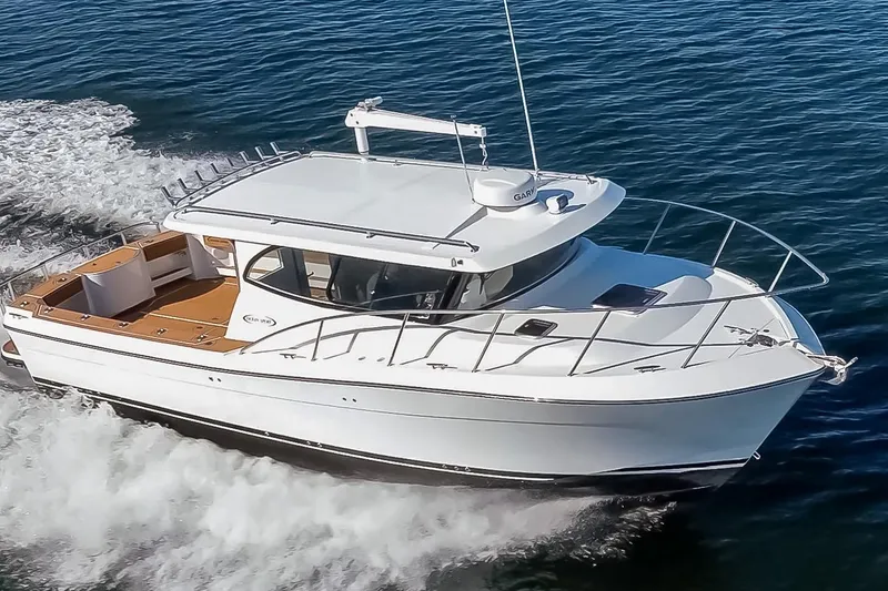 Slide: The Image of 2025 Ocean Sport Roamer cruising on open water, showcasing sleek design and performance. - 1