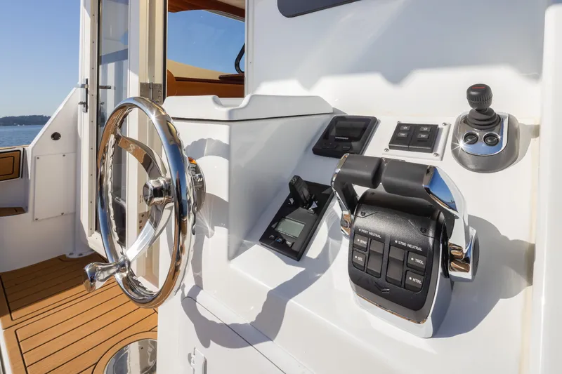 Slide: The Image of 2025 Ocean Sport Roamer helm with steering wheel and control panel. - 15