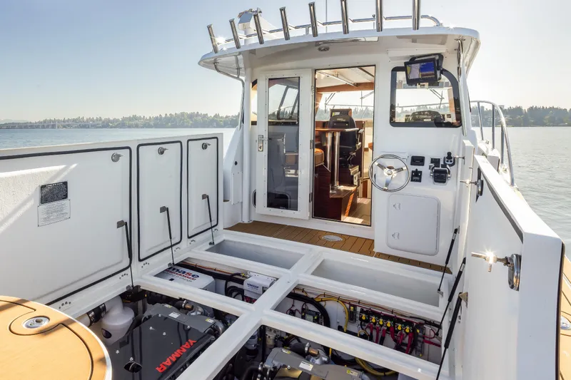 Slide: The Image of 2025 Ocean Sport Roamer boat interior with open engine compartment, showcasing modern design and equipment. - 16