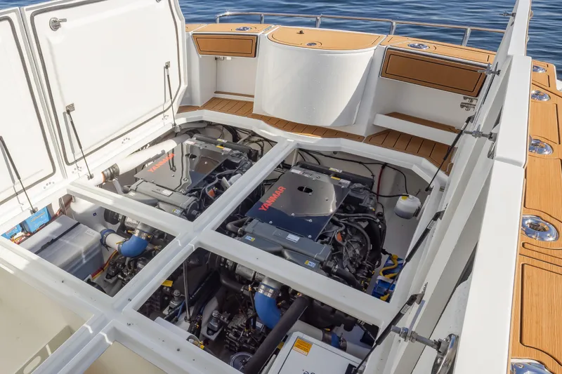 Slide: The Image of Engine compartment of 2025 Ocean Sport Roamer boat, showcasing dual Yamaha engines. - 18