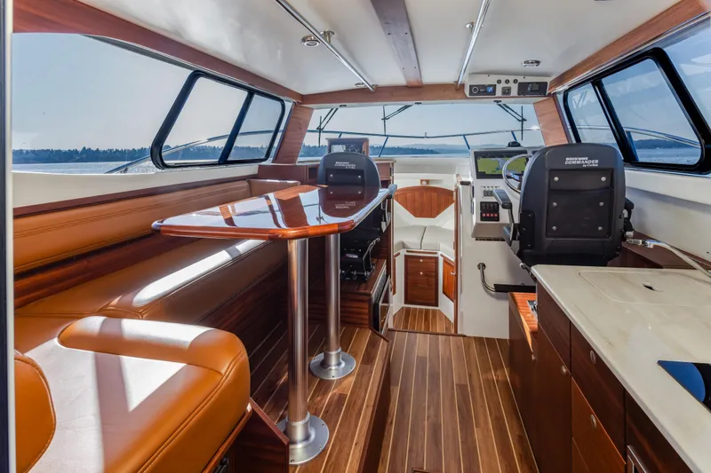Slide: The Image of Luxurious interior of 2025 Ocean Sport Roamer boat with wood accents and modern navigation equipment. - 20