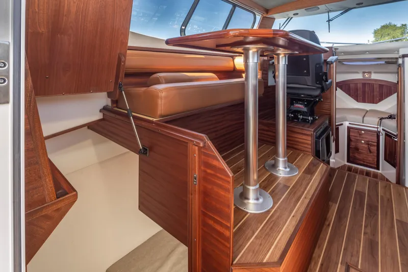 Slide: The Image of Luxurious interior of 2025 Ocean Sport Roamer boat with wood finishes and seating. - 21