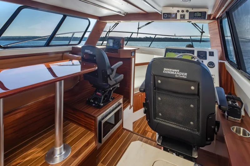 Slide: The Image of Interior of 2025 Ocean Sport Roamer boat with modern helm and seating. - 22