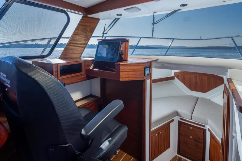 Slide: The Image of Interior of 2025 Ocean Sport Roamer boat with navigation system and seating area. - 24