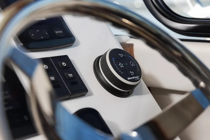 Slide: The Image of Steering wheel and controls of 2025 Ocean Sport Roamer boat cockpit. - 27