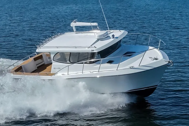 Slide: The Image of 2025 Ocean Sport Roamer cruising on open water, showcasing sleek design and performance. - 3