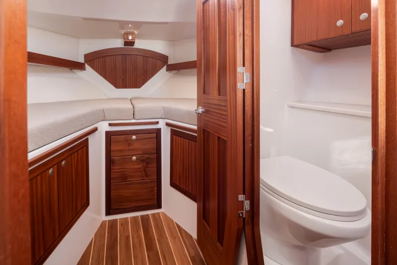 Slide: The Image of Luxurious 2025 Ocean Sport Roamer boat interior with wood accents and modern amenities. - 32