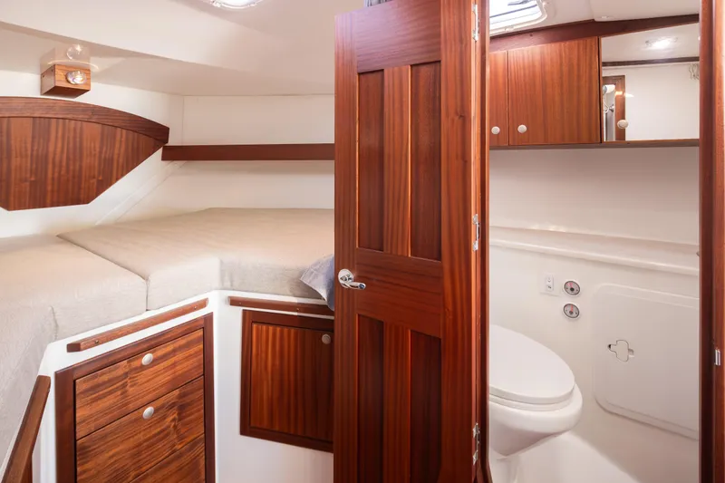 Slide: The Image of Luxurious 2025 Ocean Sport Roamer cabin interior with wooden finishes and compact bathroom. - 35